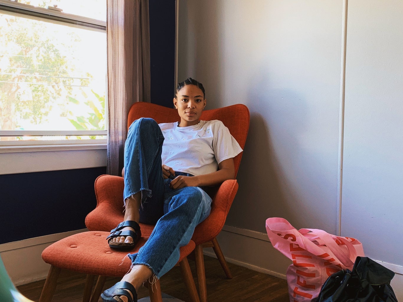 young woman sitting in dorm room