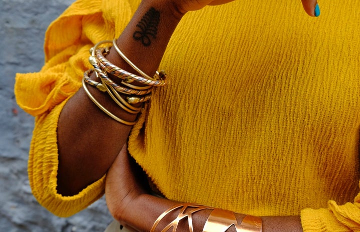 Woman arms and hands covered in jewelry