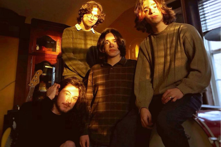 4 guys posing for a band photo