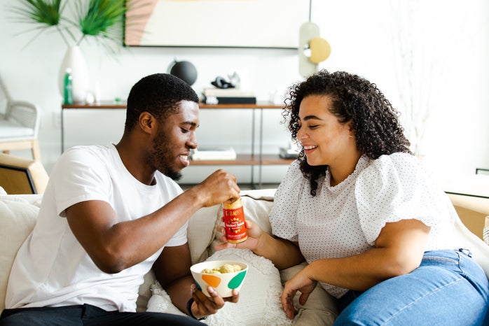 couple snacking on couch