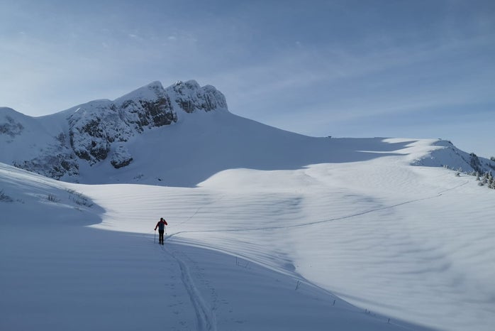 a person ski touring in the mountain