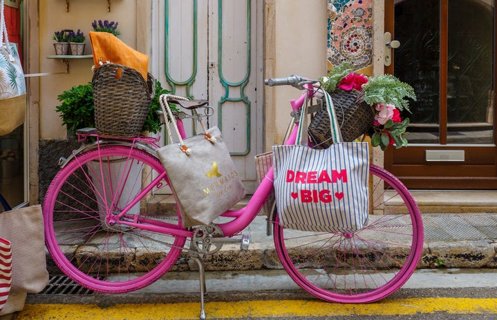 pink bicycle in front of a stoop