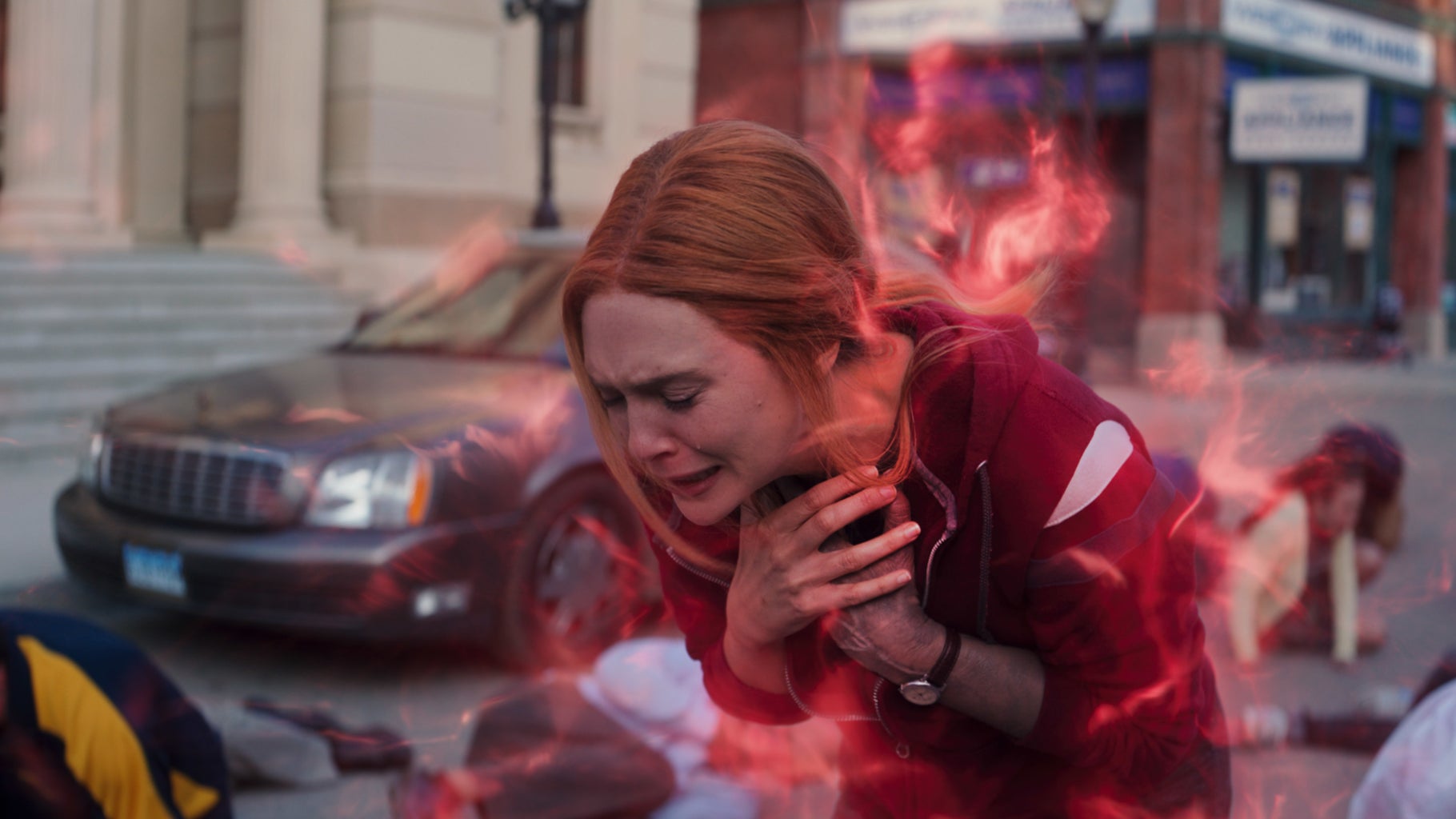 Wanda Maximoff embracing Vision in a surreal suburban setting