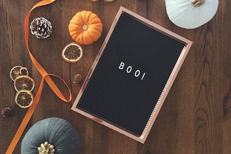 letter box with boo! on it and small pumpkins