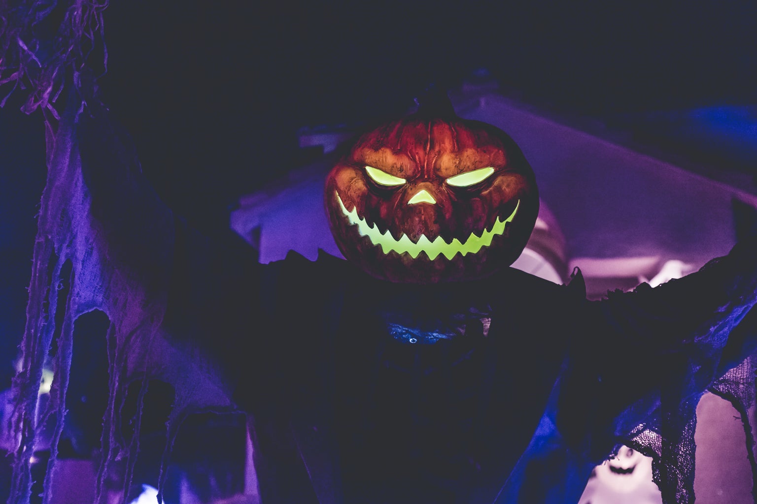 Creepy pumpkin headed creature in a Halloween setting