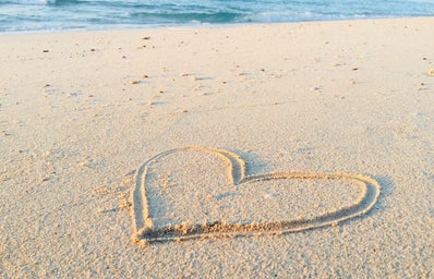 Heart drawn in the sand of the beach