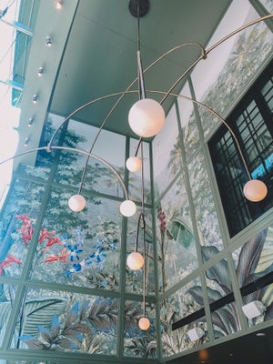 ceiling of coffee shop with green colorful floral mural