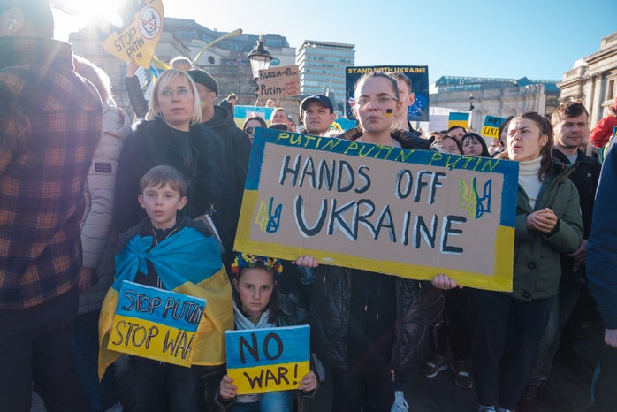 Ukraine protests, family, signs \'no war\' and \'hands off Ukraine\'