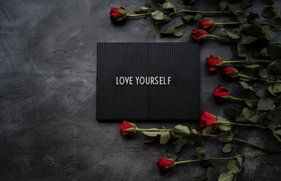 Love yourself with a black background and roses
