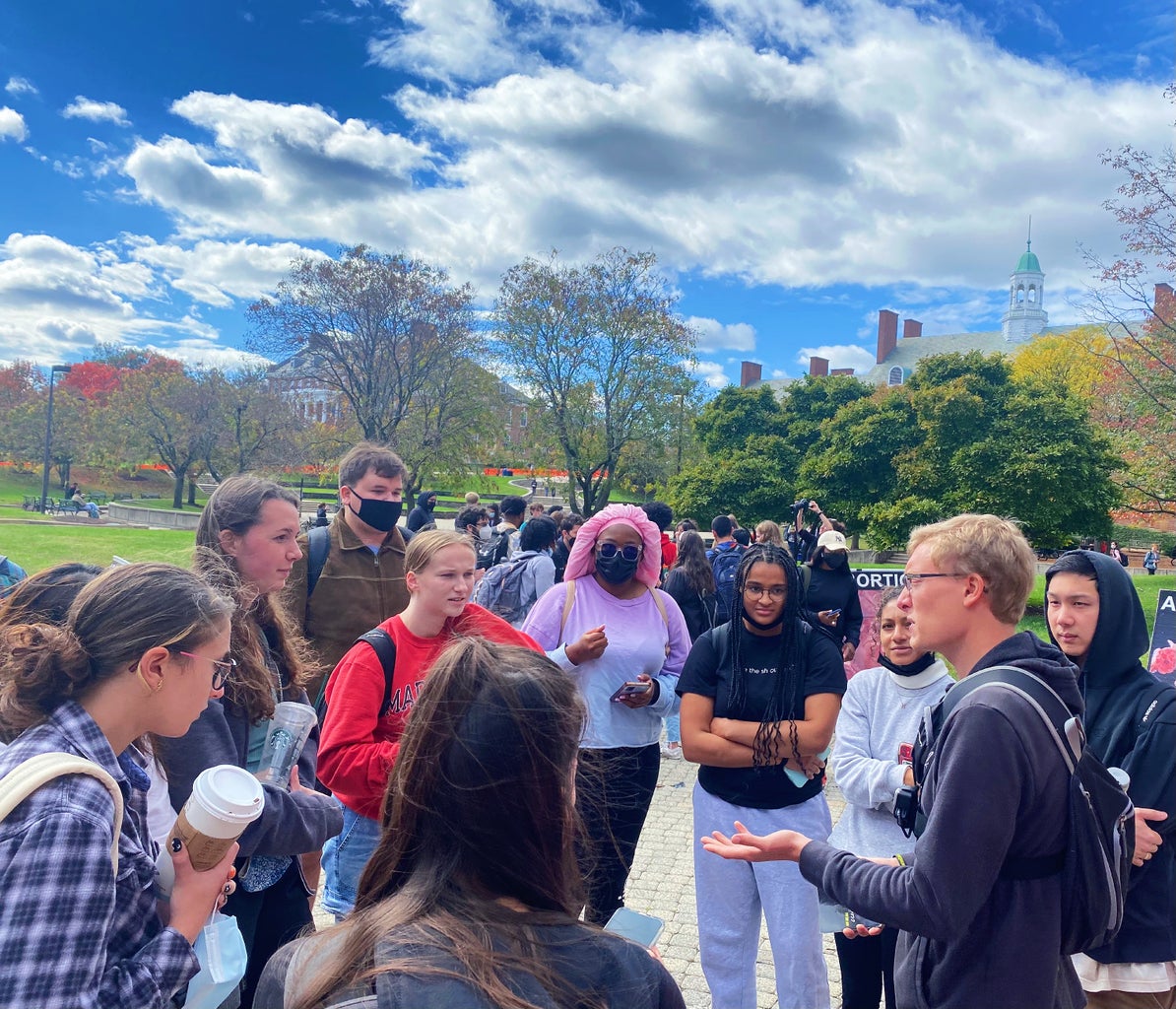 Protestors speaking with students