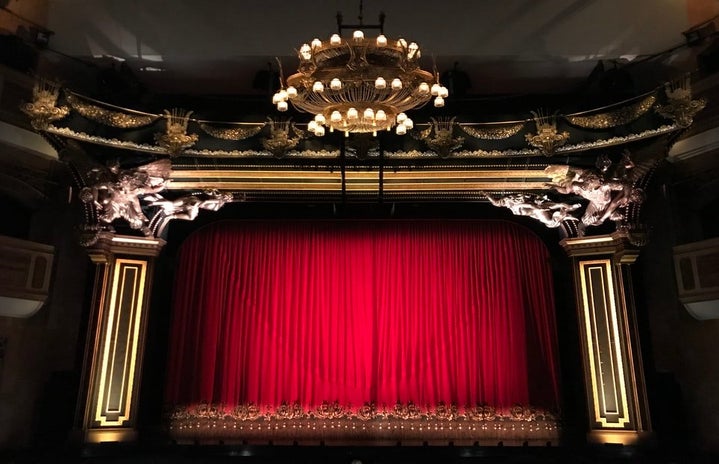 red curtains on a stage by Gwen O on unsplash?width=719&height=464&fit=crop&auto=webp