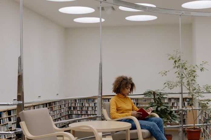 young woman reading in library
