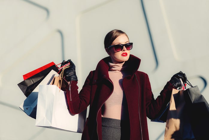 Lady holding several shopping bags in both of her hands