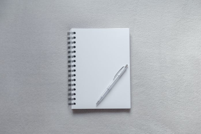 White notebook with a pen