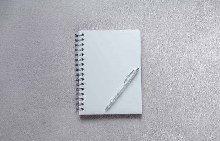 White notebook with a pen