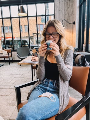 girl holding a small hot coffee cup