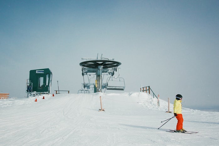 utah ski lift in winter with skiers around it