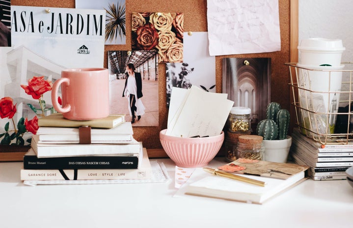pink mug on stacked books