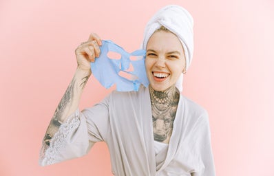 happy woman removing a face mask