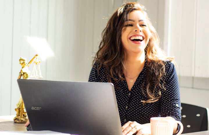woman at laptop laughing