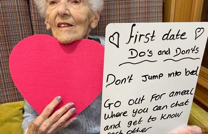 Elderly people holding up signs with their dating tips