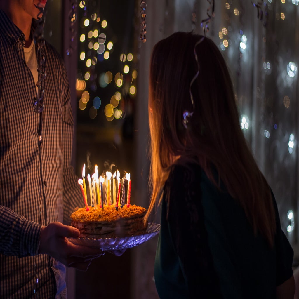 girl blowing out birthday candles