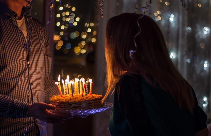 girl blowing out birthday candles