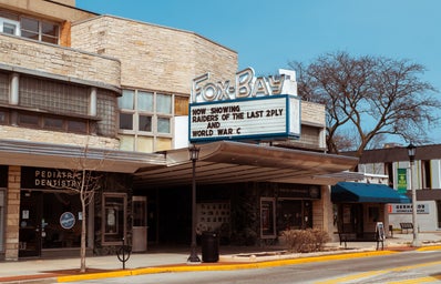 Movie theatre sign in Whitefish Bay, Wi saying \"Now showing \'Raiders of the last 2 Ply\' and \'World War C\'\" in reference to COVID-19.