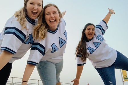 Three friends in sorority jerseys