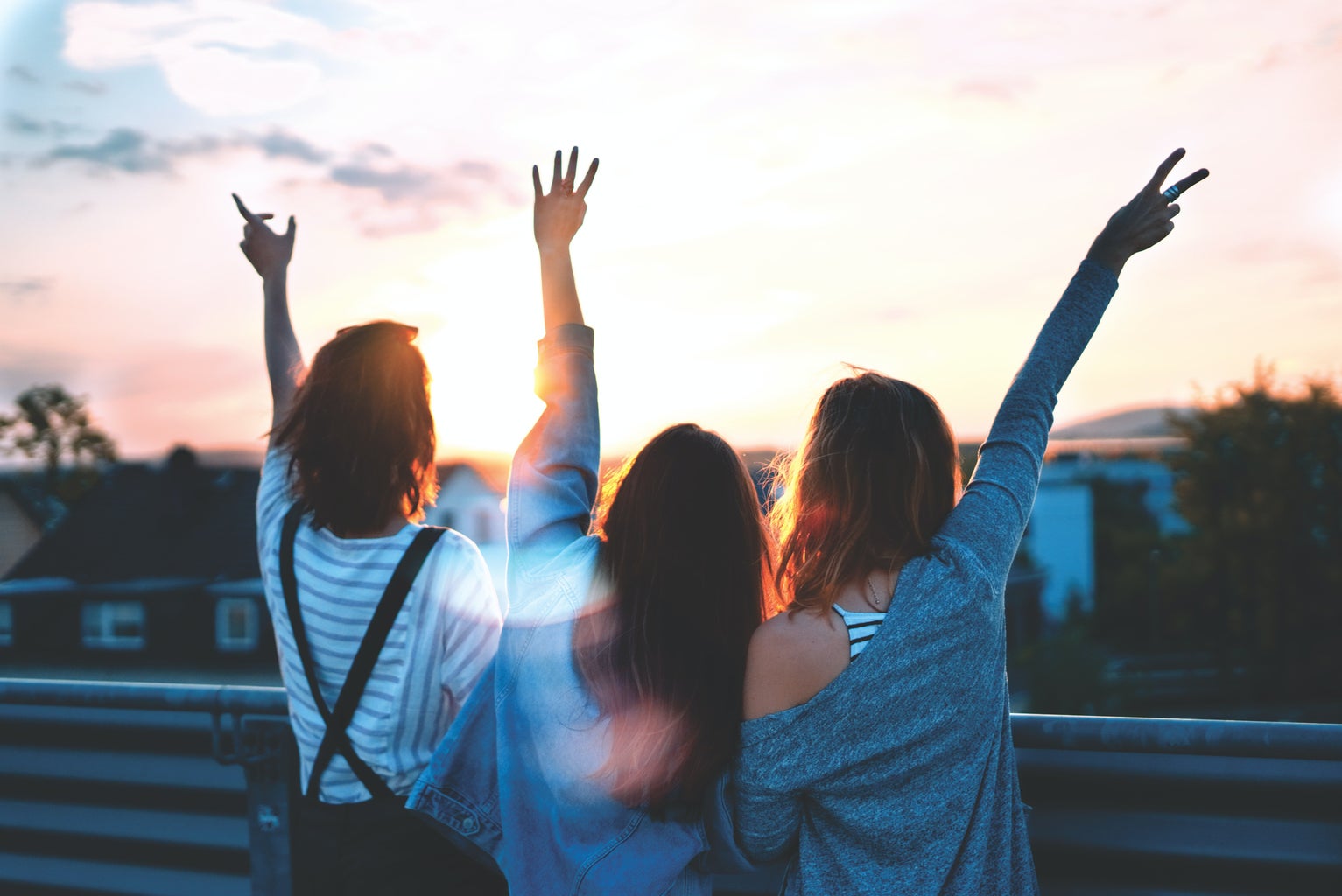 image of three friends watching the sunset