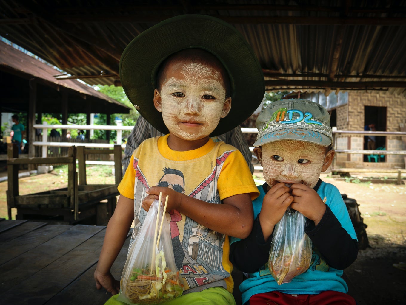 kids with thanakha (sun protection), smiling, on the way to Hsipaw, Mynmar