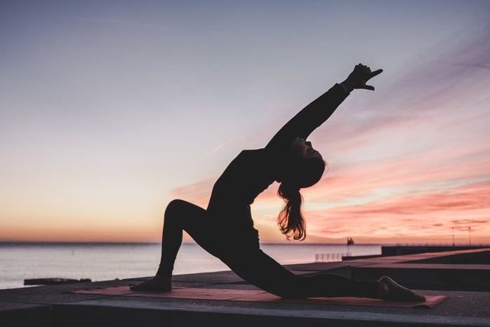woman doing yoga at sunset by Unsplash?width=698&height=466&fit=crop&auto=webp