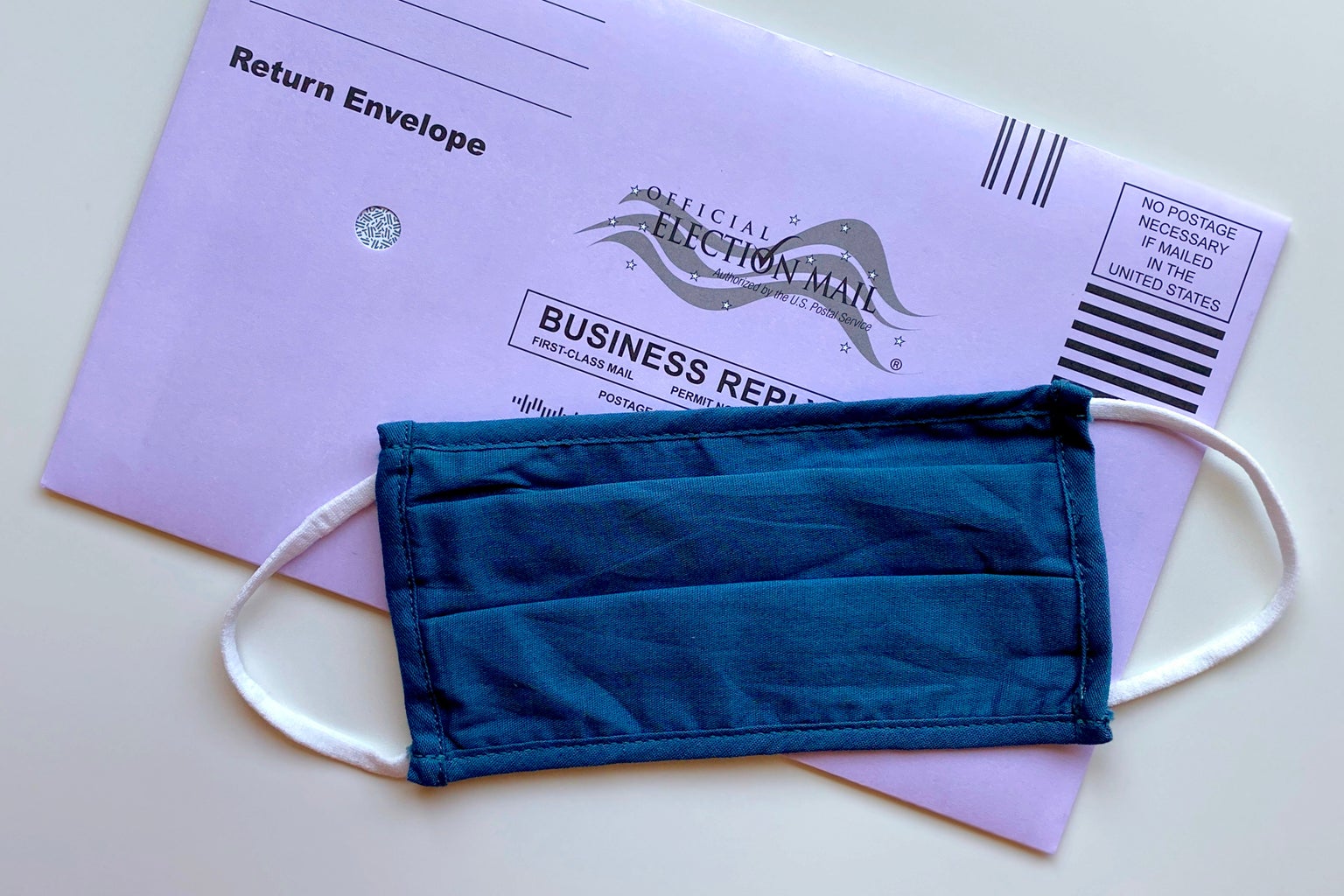 mail in ballot with mask by Tiffany Tertipes on Unsplash