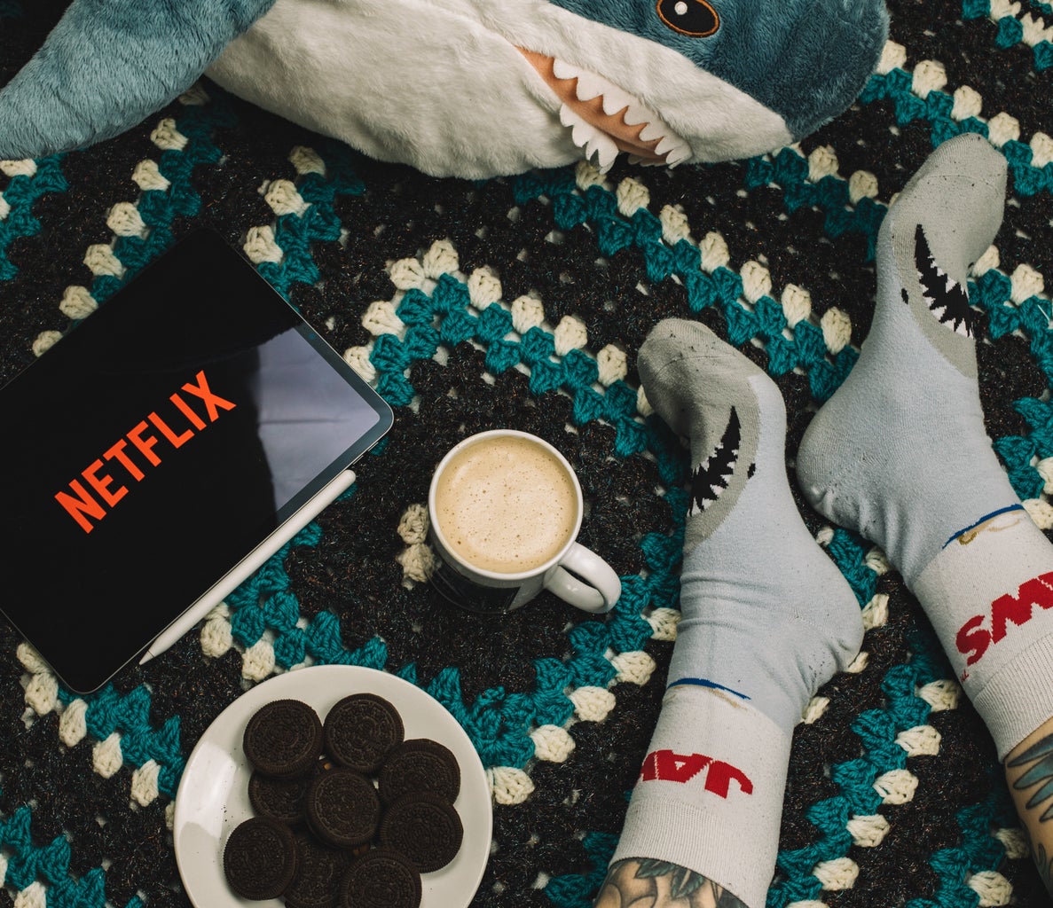 Screen with Netflix Logo, plate of cookies, coco, and shark Socks