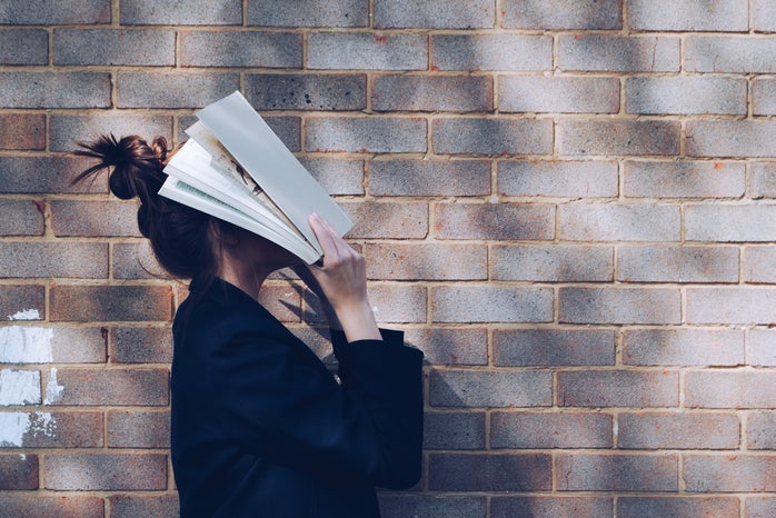 woman with books on face by Siora Photography on Unsplash?width=698&height=466&fit=crop&auto=webp