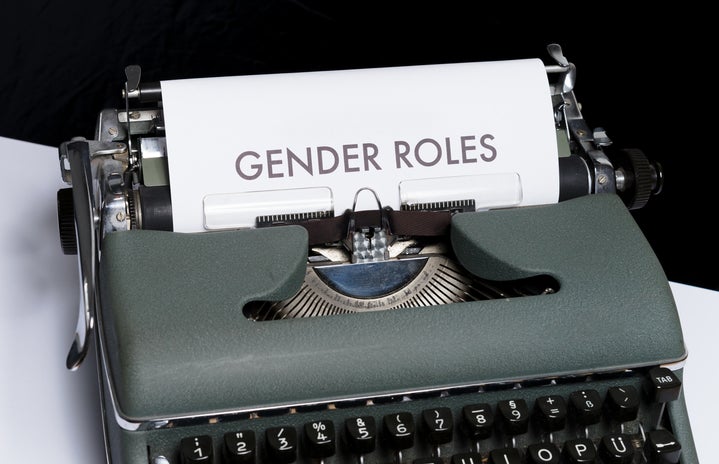 gender roles typed on paper in green typewriter
