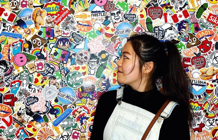Emily Lin in front of sticker wall