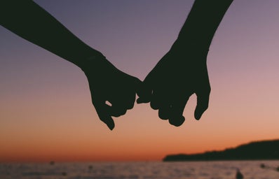 holding hands at sunset