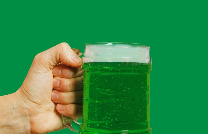 person holding green beverage