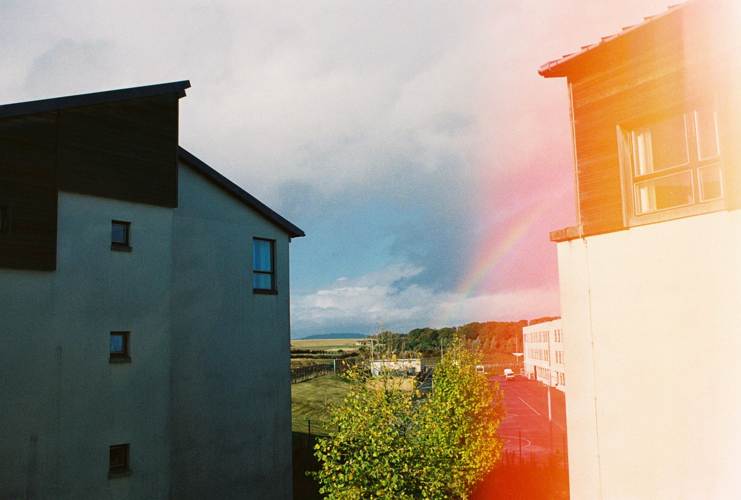 Landscape with buildings and rainbow