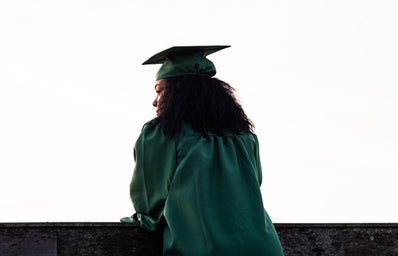 The back profile of a graduate in a cap and gown.