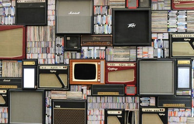 wall of records and vintage amplifiers and speakers