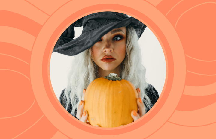 woman with witch hat and pumpkin