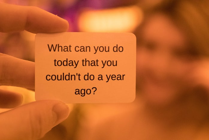 person holding a card that says \"what can you do today you couldn\'t do a year ago?