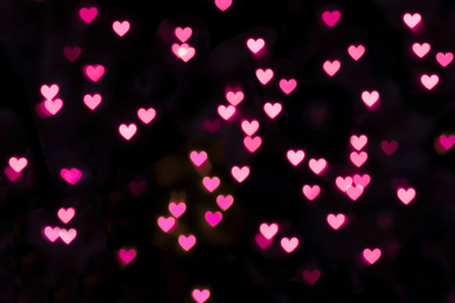 Pink hearts on black background