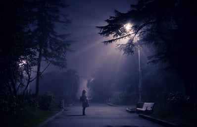 person looking at street lamp