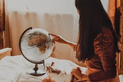 woman and a globejpg by Unsplash?width=698&height=466&fit=crop&auto=webp