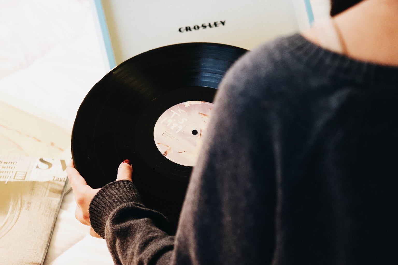 person holding a black vinyl record