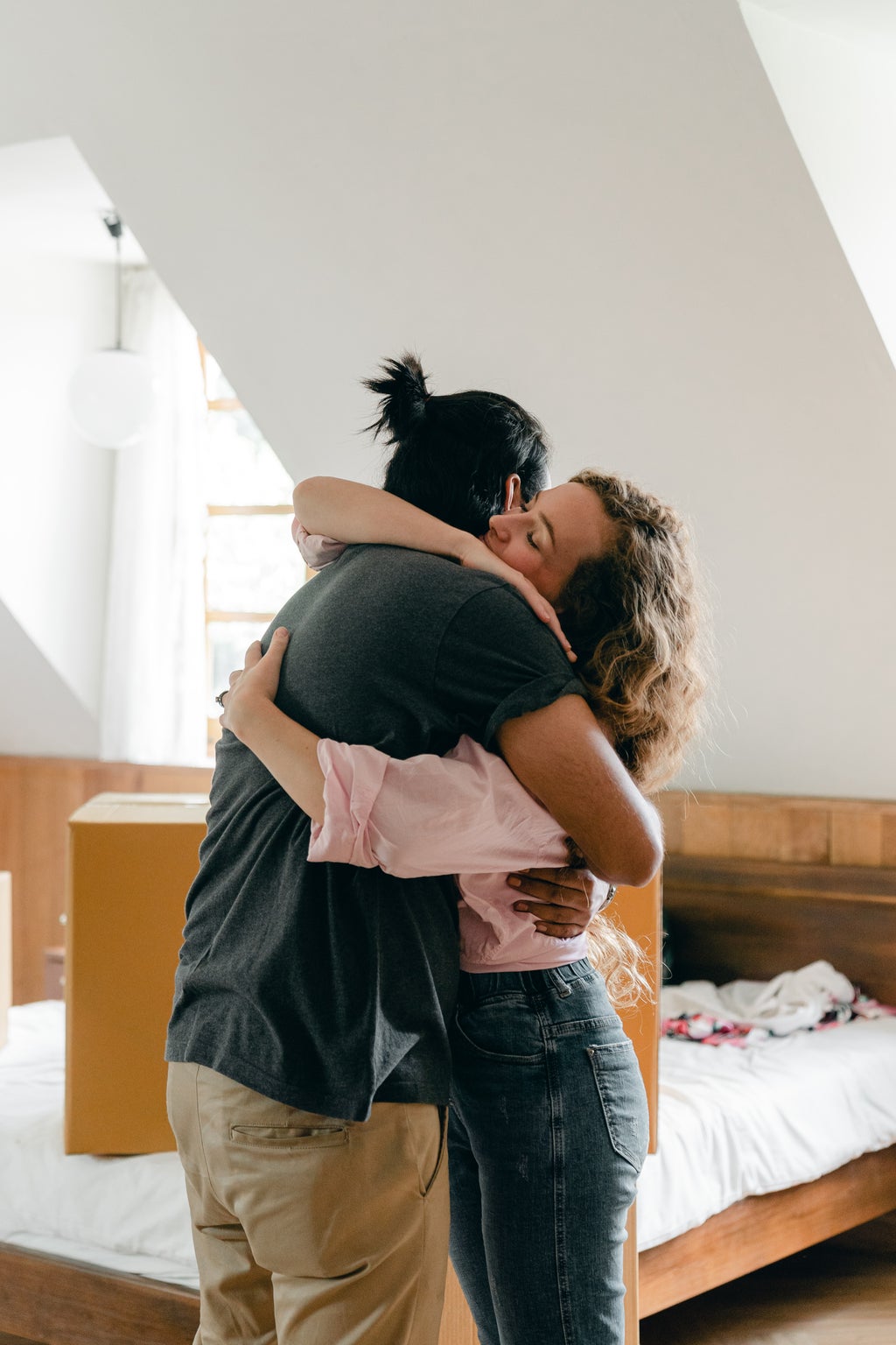 happy couple hugging in apartment