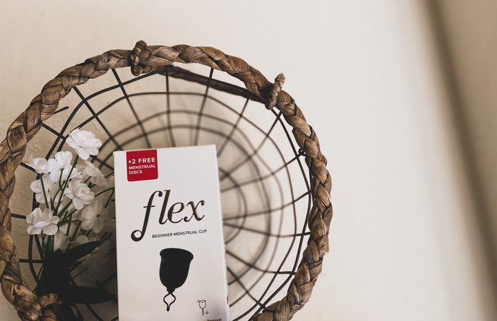 flex menstrual cup box in a basket with flowers